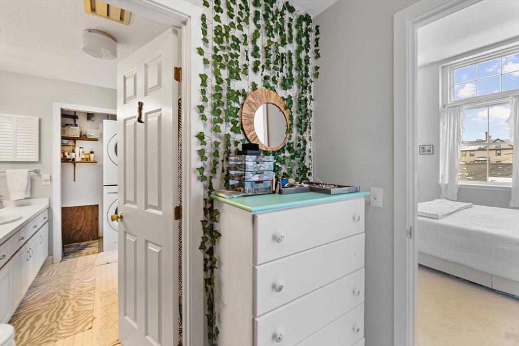 51 Pettee Street, Unit 31 Newton, MA 02464 - Photo 11 of 15 a en suite bathroom with a granite countertop sink and a mirror