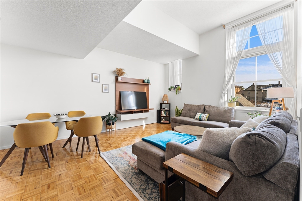 51 Pettee Street, Unit 31 Newton, MA 02464 - Photo 2 of 15 a living room with furniture and a fireplace
