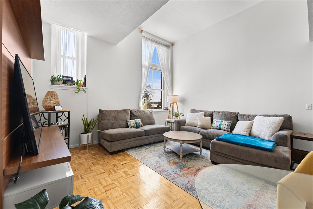 51 Pettee Street, Unit 31 Newton, MA 02464 - Photo 3 of 15 a living room with furniture fireplace and a flat screen tv