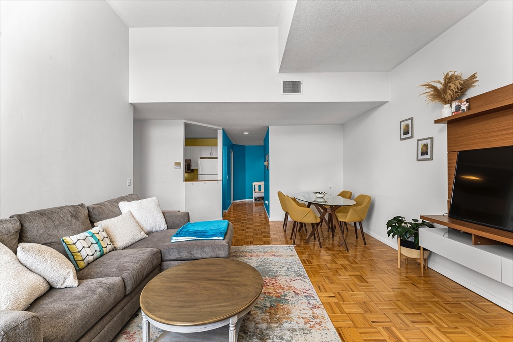 51 Pettee Street, Unit 31 Newton, MA 02464 - Photo 4 of 15 a living room with furniture a flat screen tv and a dining table
