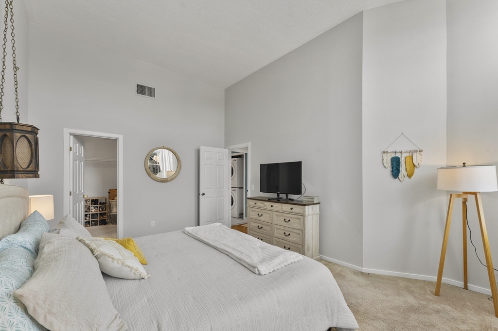 51 Pettee Street, Unit 31 Newton, MA 02464 - Photo 10 of 15 a bedroom with a bed and a flat tv screen on dresser