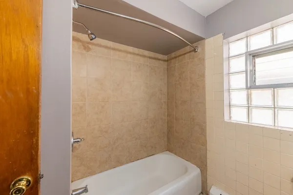 a bathroom with a tub and a shower