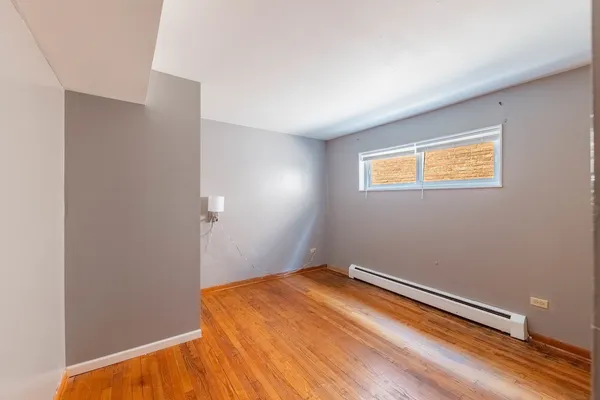 a bedroom with a bed and a painting on the wall