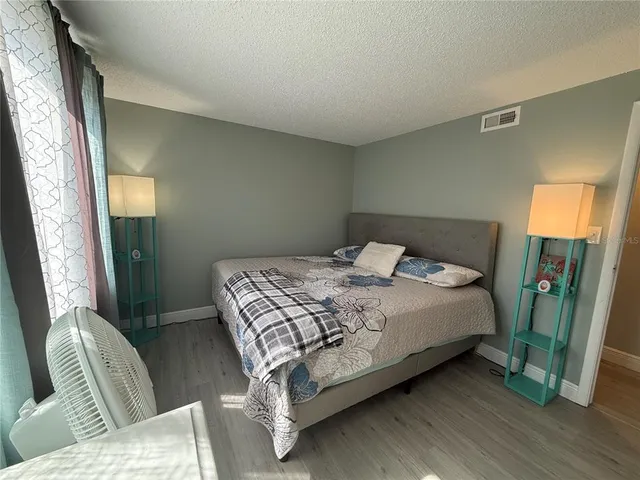 a bedroom with a bed and a mirror