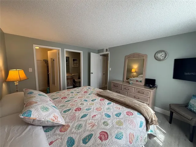 a bedroom with a bed and a television