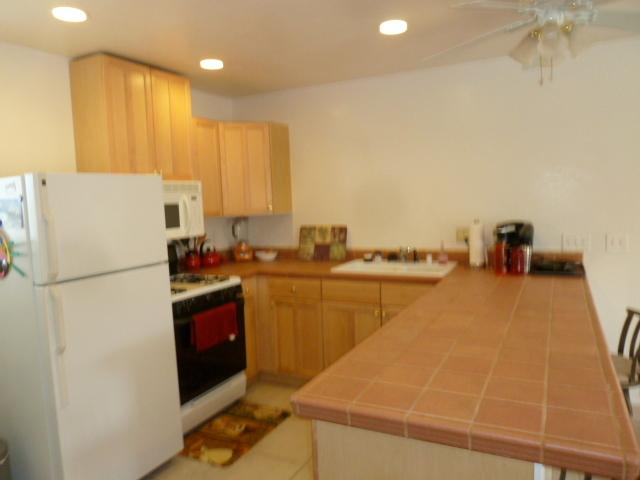 4559 Rolfe Road San Diego, CA 92117 - Photo 23 of 25 Studio/ kitchen: full size 4-burner gas stove, microwave, fridge, dishwasher; ample cabinet space, counters - just awesome.Laundry in unit, stackable in closet between kitchen and bathroom. All these appliances will convey with property.