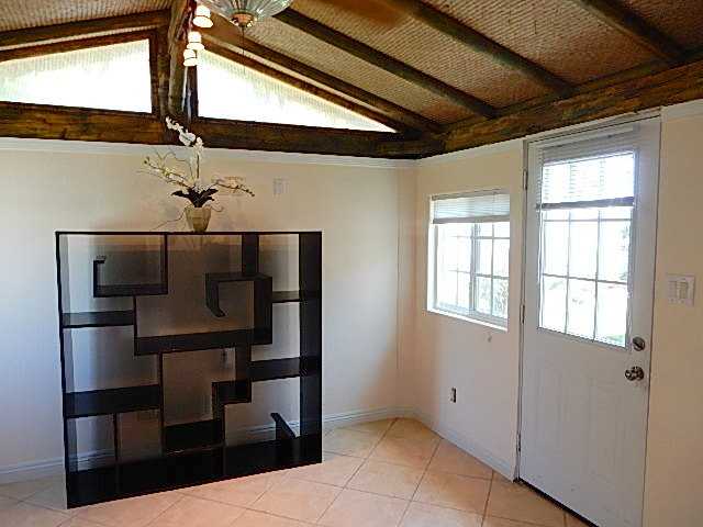 4559 Rolfe Road San Diego, CA 92117 - Photo 10 of 25 Office/Den off master bedroom, appx 12x 10.5, high ceiling, wall cooling/heating unit, door to back yard & patio