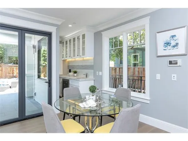 a view of a dining room with furniture large windows and wooden floor