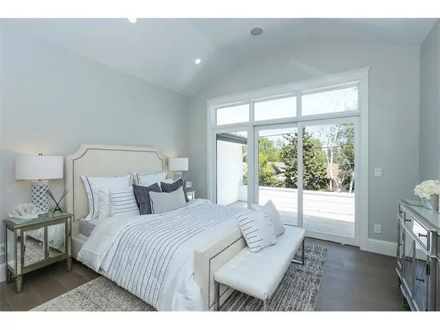 a bedroom with a bed and a large window