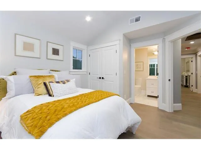 a bedroom with a bed and a couch