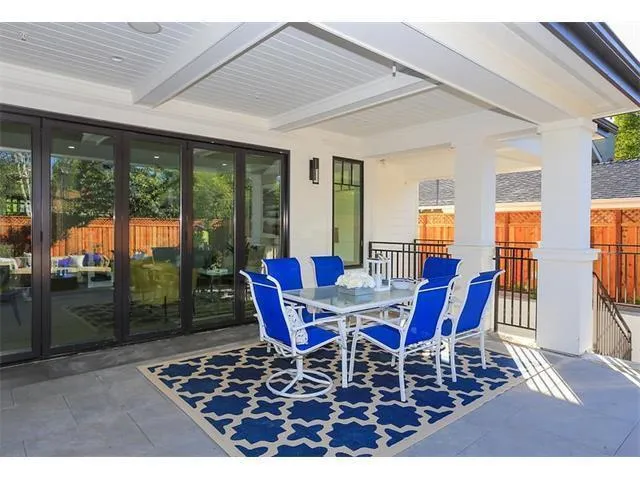 a view of a dining room with furniture large windows and wooden floor