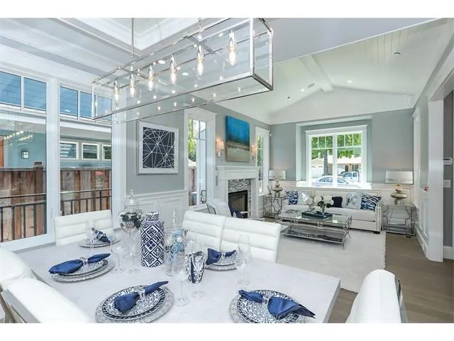 a living room with furniture fireplace and a large window