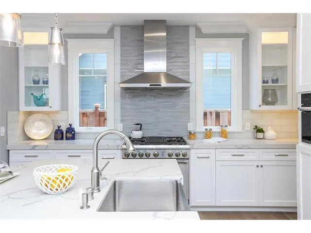 a kitchen with a stove a sink and a cabinets
