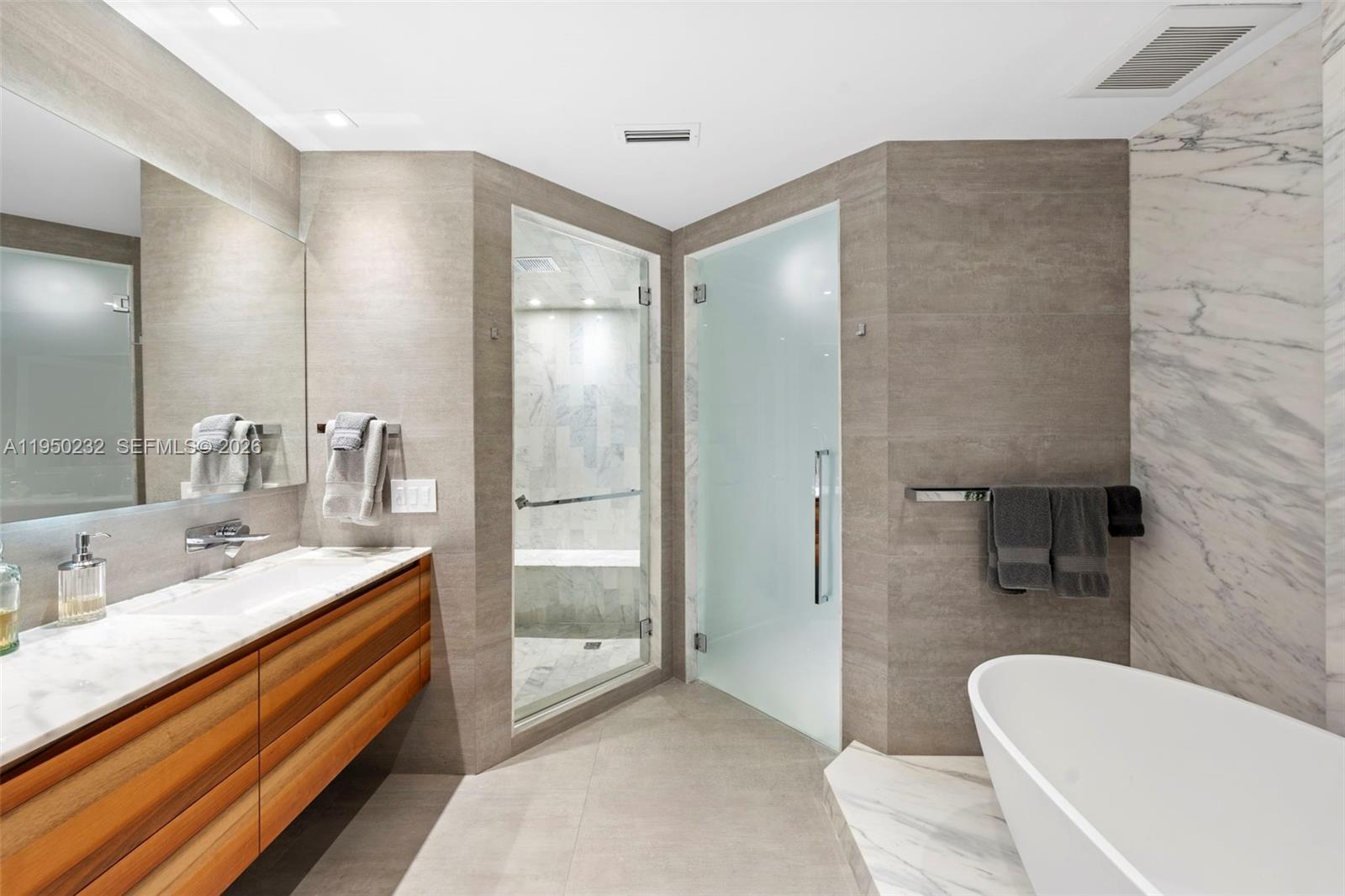 1000 South Pointe Drive, Unit 2802 Miami Beach, FL 33139 - Photo 20 of 44 a bathroom with a double vanity sink toilet and shower