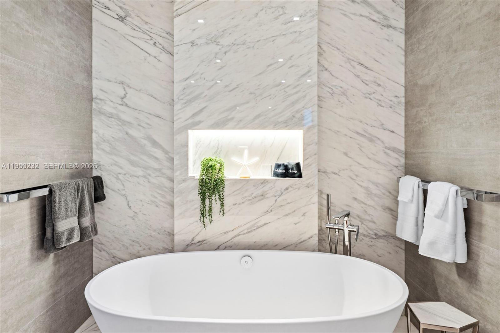 1000 South Pointe Drive, Unit 2802 Miami Beach, FL 33139 - Photo 22 of 44 a white bath tub sitting in a bathroom