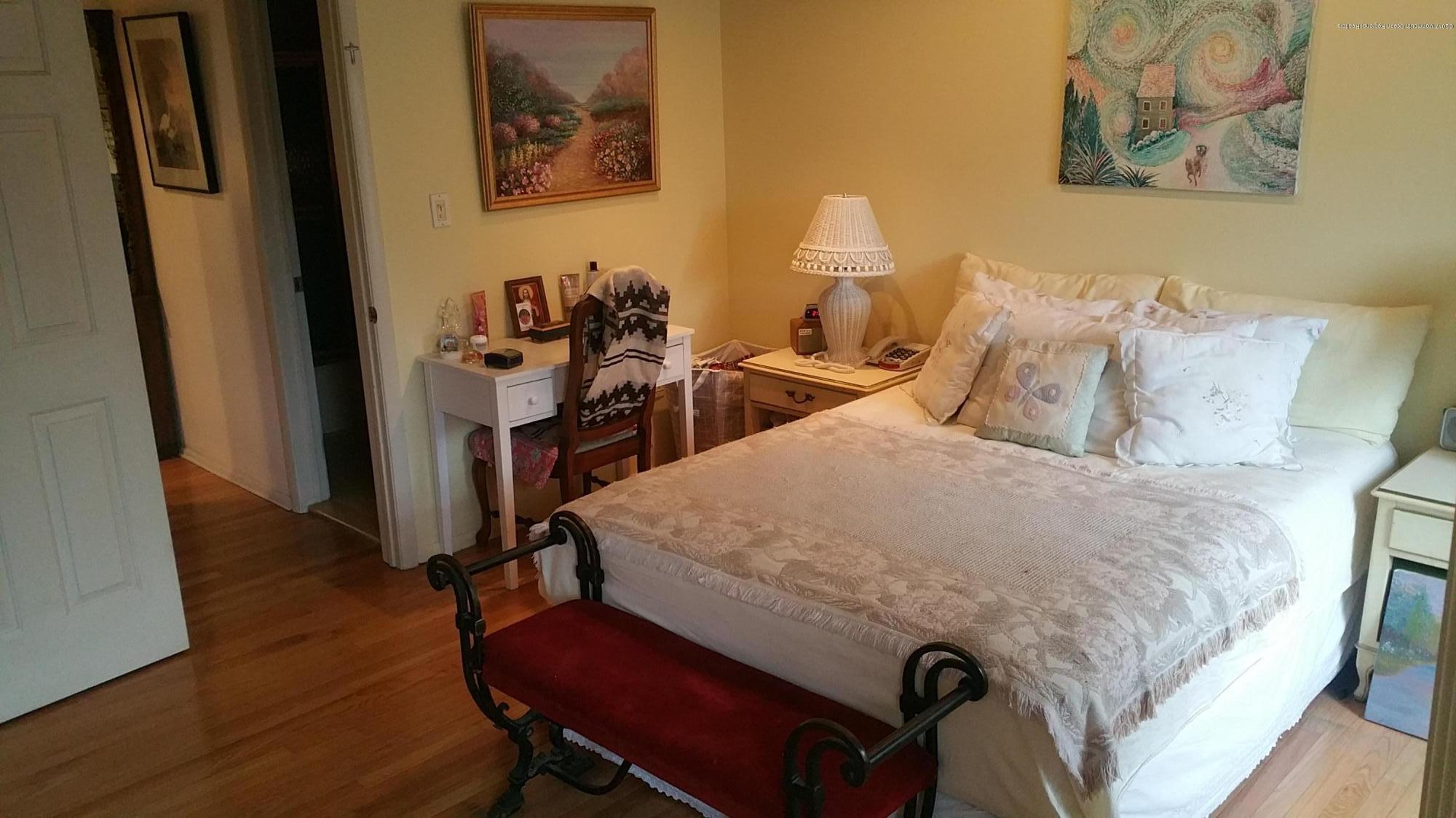 200 Portland Road, Unit C6 Highlands, NJ 07732 - Photo 11 of 19 a bed sitting in a bedroom next to a window
