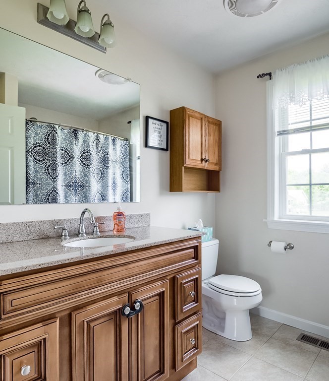 245 Pleasantdale Road Rutland, MA 01543 - Photo 12 of 24 a bathroom with a toilet sink and mirror