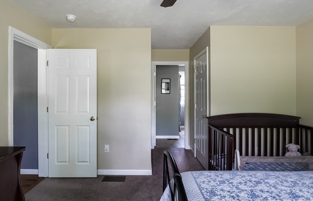 245 Pleasantdale Road Rutland, MA 01543 - Photo 14 of 24 a bedroom with a bed and wooden floor