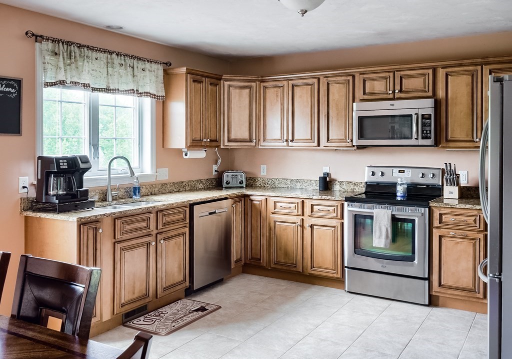 245 Pleasantdale Road Rutland, MA 01543 - Photo 2 of 24 a kitchen with stainless steel appliances granite countertop a stove sink and cabinets