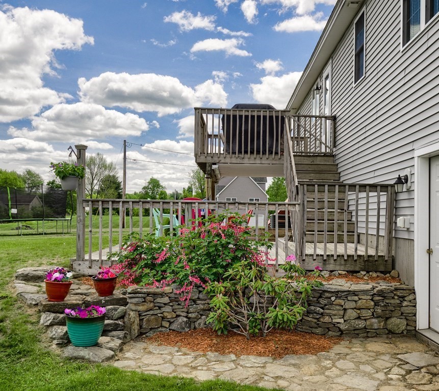 245 Pleasantdale Road Rutland, MA 01543 - Photo 21 of 24 a view of a chair and tables in backyard of the house