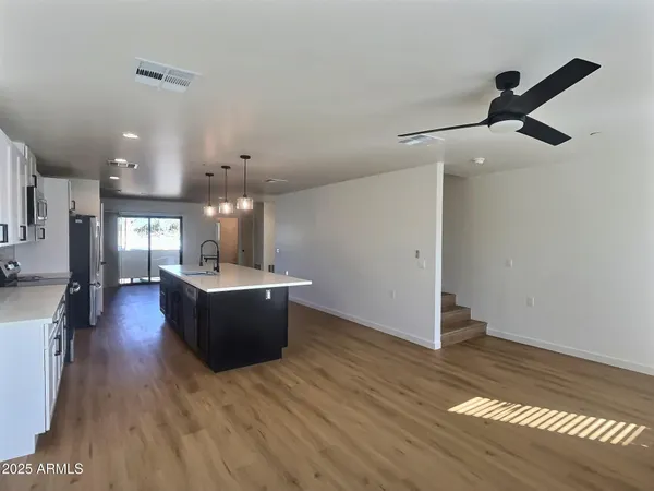 a kitchen with granite countertop white cabinets and stainless steel appliances