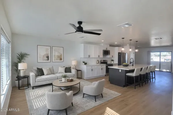 a large kitchen with a lot of counter space and stainless steel appliances