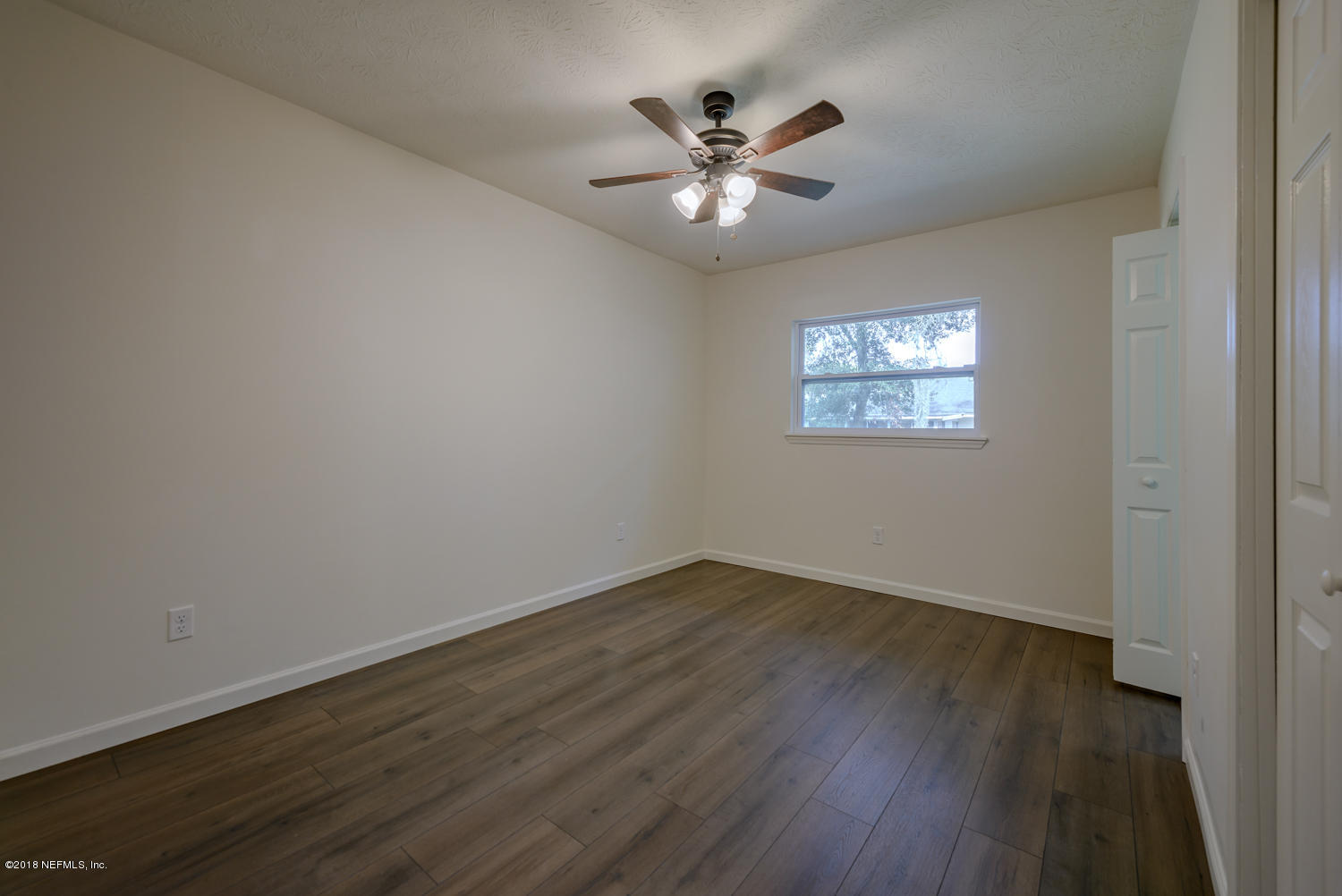 117 Tanager Road St. Augustine, FL 32086 - Photo 15 of 30 a view of an empty room with wooden floor and a window