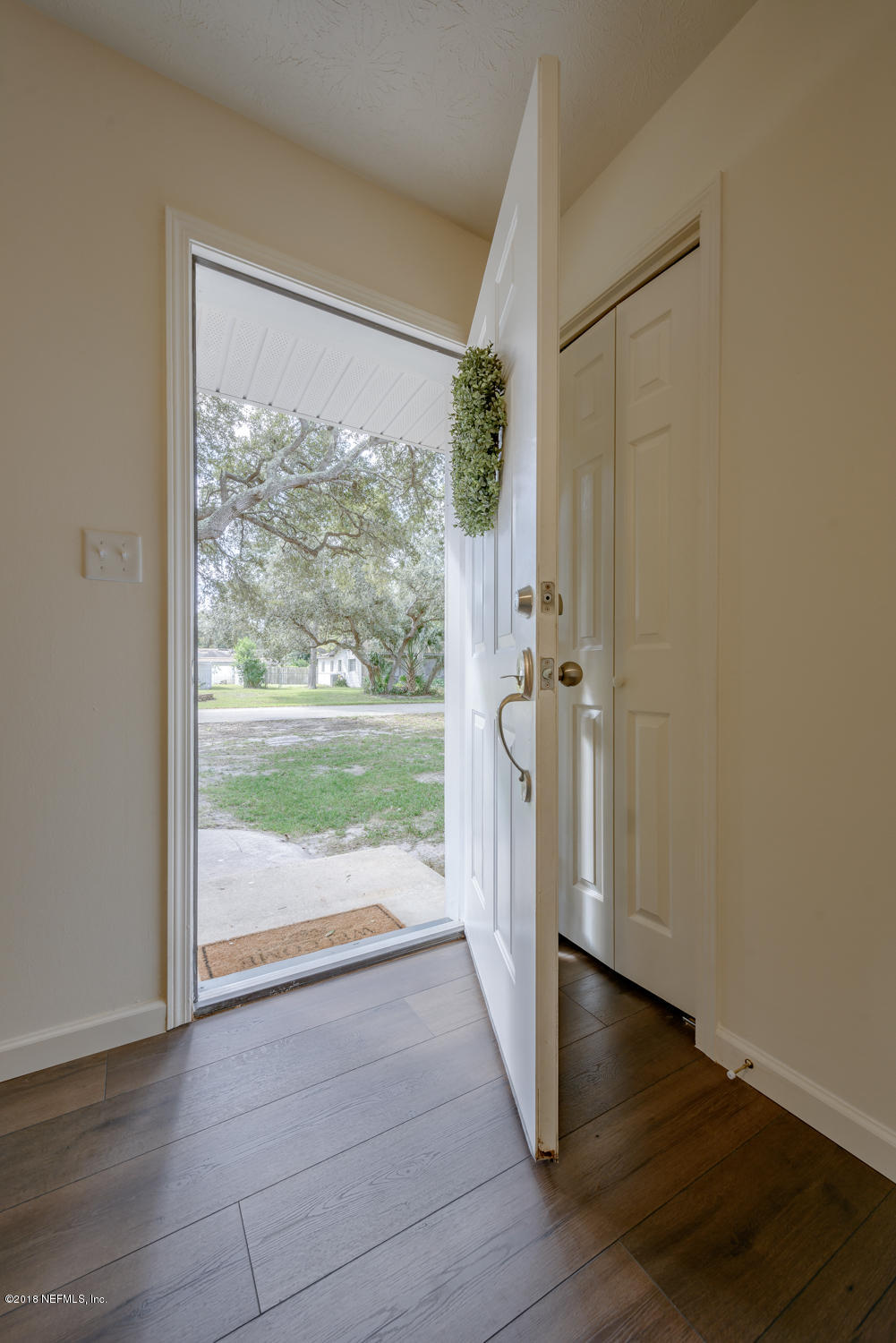 117 Tanager Road St. Augustine, FL 32086 - Photo 4 of 30 wooden floor in an empty room with a window