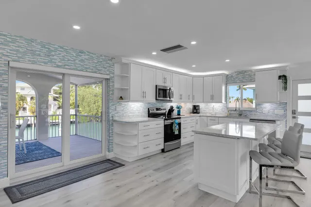 a kitchen with counter top space cabinets and appliances