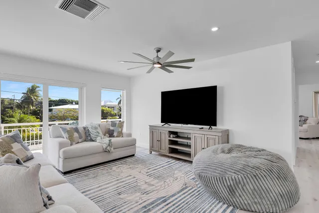 a bedroom with a bed a couch and a flat screen tv