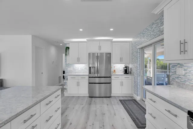 a kitchen with a sink stainless steel appliances and cabinets