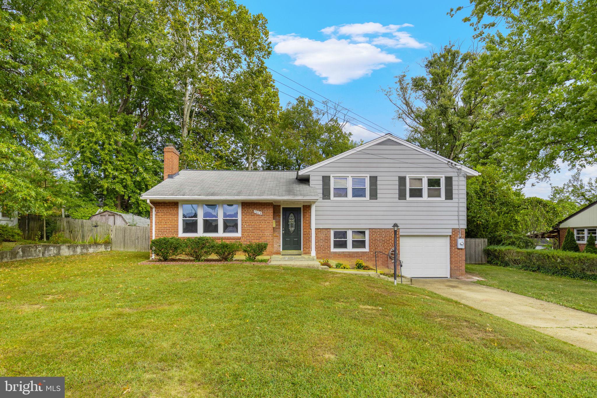 7414 Chatham Street Springfield, VA 22151 - Photo 1 of 34 a front view of a house with a garden
