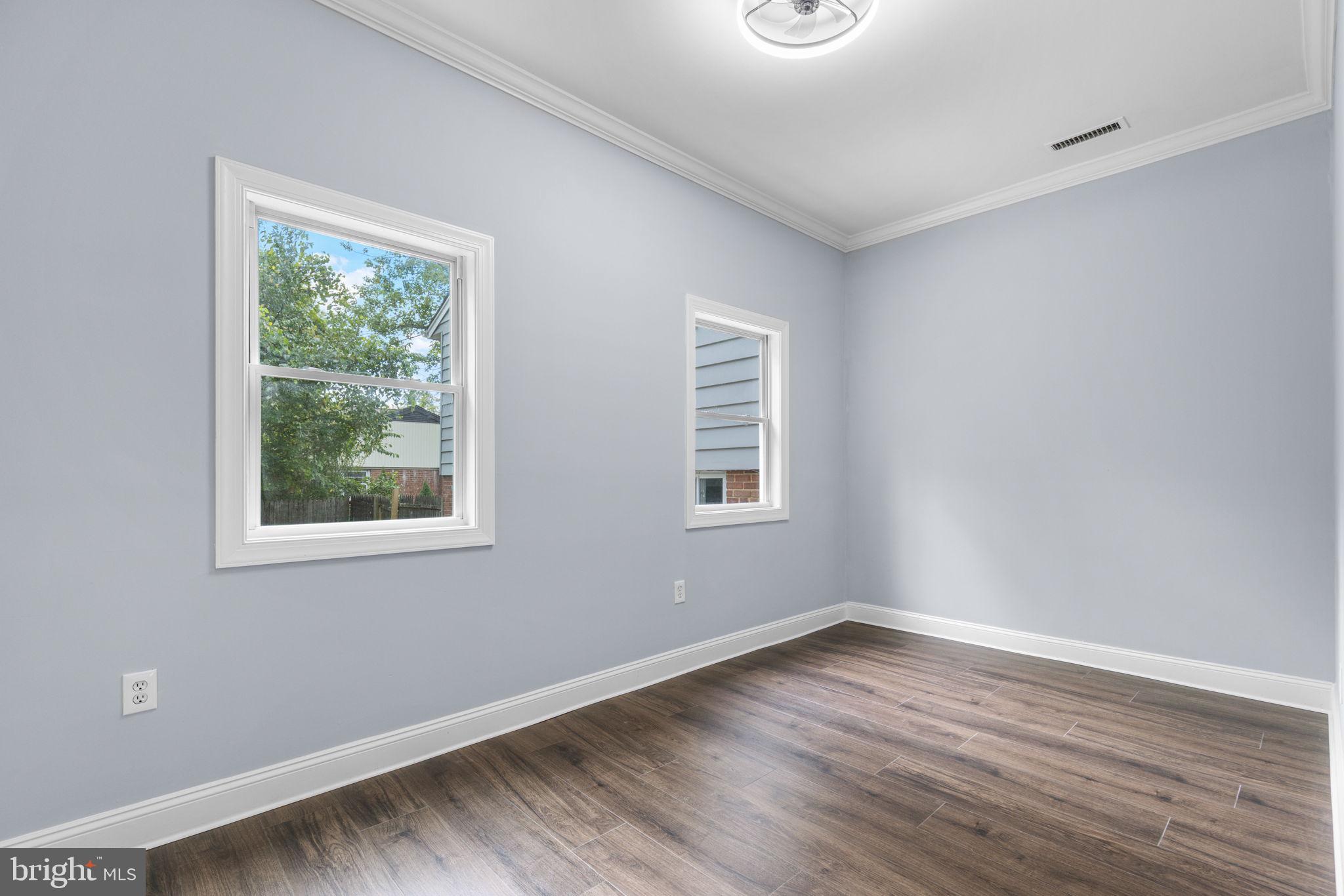 7414 Chatham Street Springfield, VA 22151 - Photo 17 of 34 a view of an empty room with wooden floor and a window