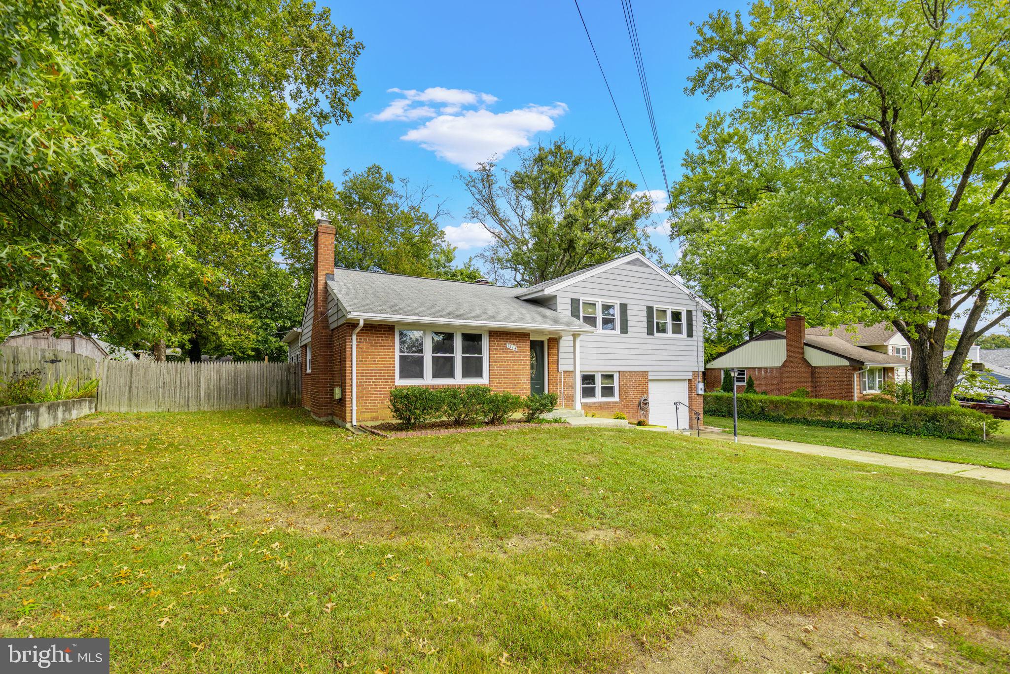 7414 Chatham Street Springfield, VA 22151 - Photo 3 of 34 a front view of a house with a yard and trees
