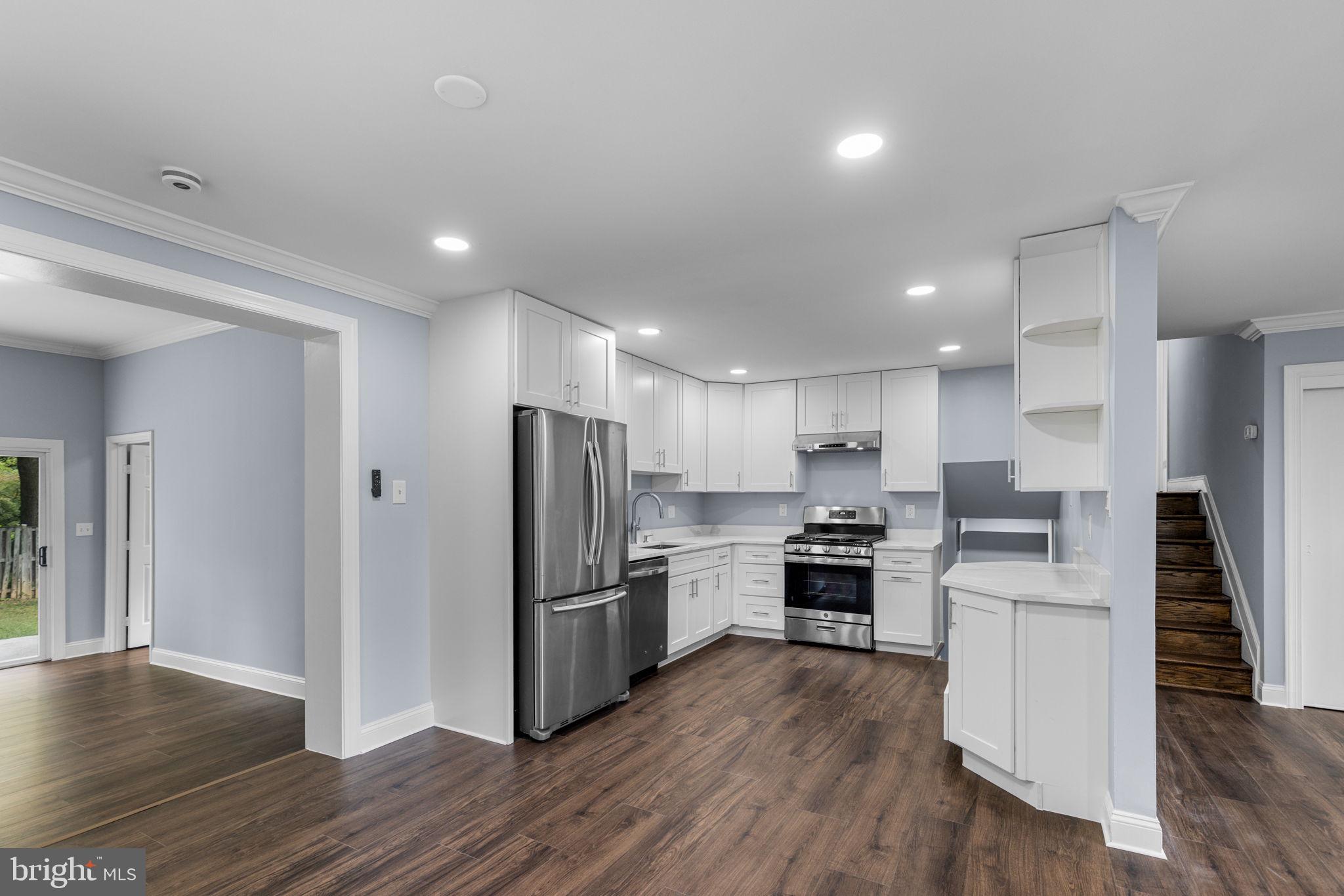 7414 Chatham Street Springfield, VA 22151 - Photo 9 of 34 a kitchen with stainless steel appliances wooden floor and a refrigerator