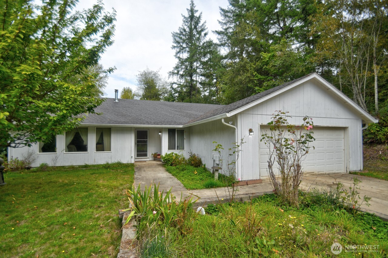 13920 Littlerock Road Southwest Rochester, WA 98579 - Photo 1 of 23 a front view of a house with garden