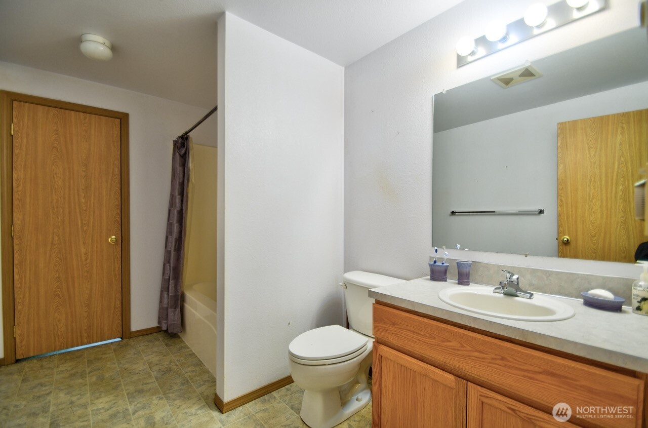 13920 Littlerock Road Southwest Rochester, WA 98579 - Photo 17 of 23 a bathroom with a granite countertop sink toilet and shower