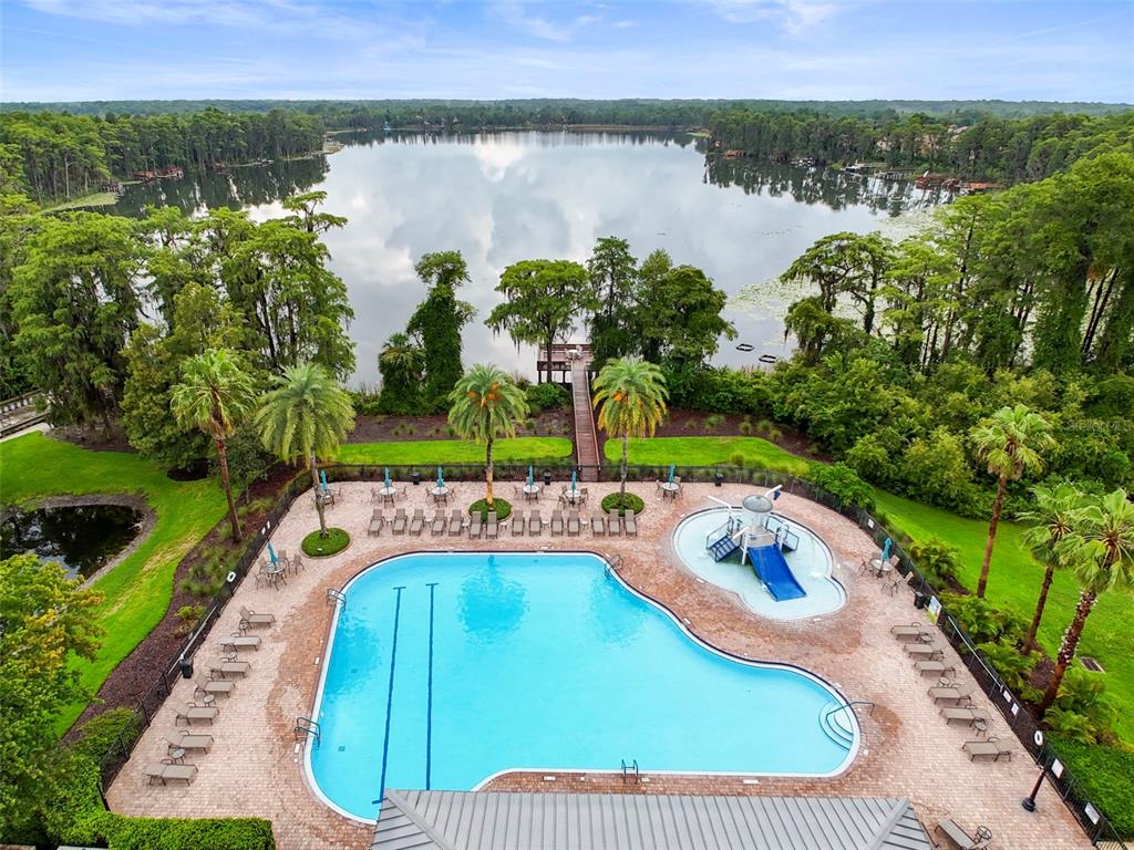 11807 Castine Street New Port Richey, FL 34654 - Photo 36 of 40 a view of a swimming pool with a yard and lake view