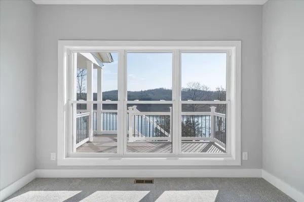 a view of a house with a yard and a large tree