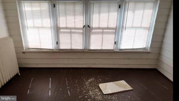 a view of wooden floor and windows in a room
