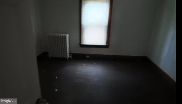 a view of an empty room and wooden floor