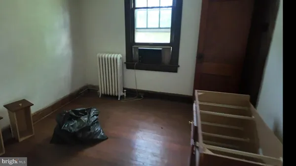 a room with hard wood floors and a window