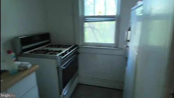 a kitchen with a stove and a window