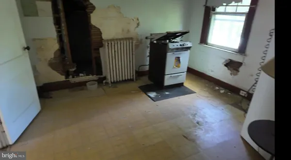 a view of a livingroom with entryway and window