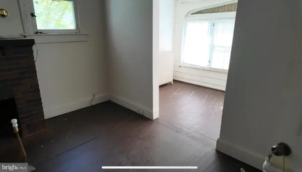 a view of a room with wooden floor and window