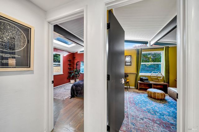 a view of living room filled with furniture and a window
