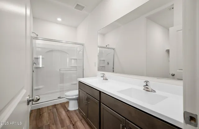 a bathroom with a sink shower and a mirror