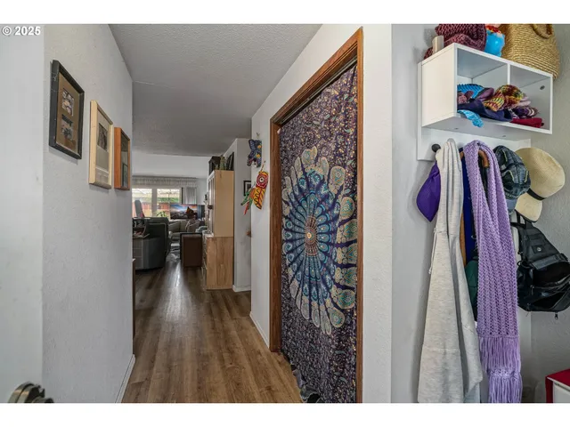 a living room with furniture a rug a fireplace and a large window