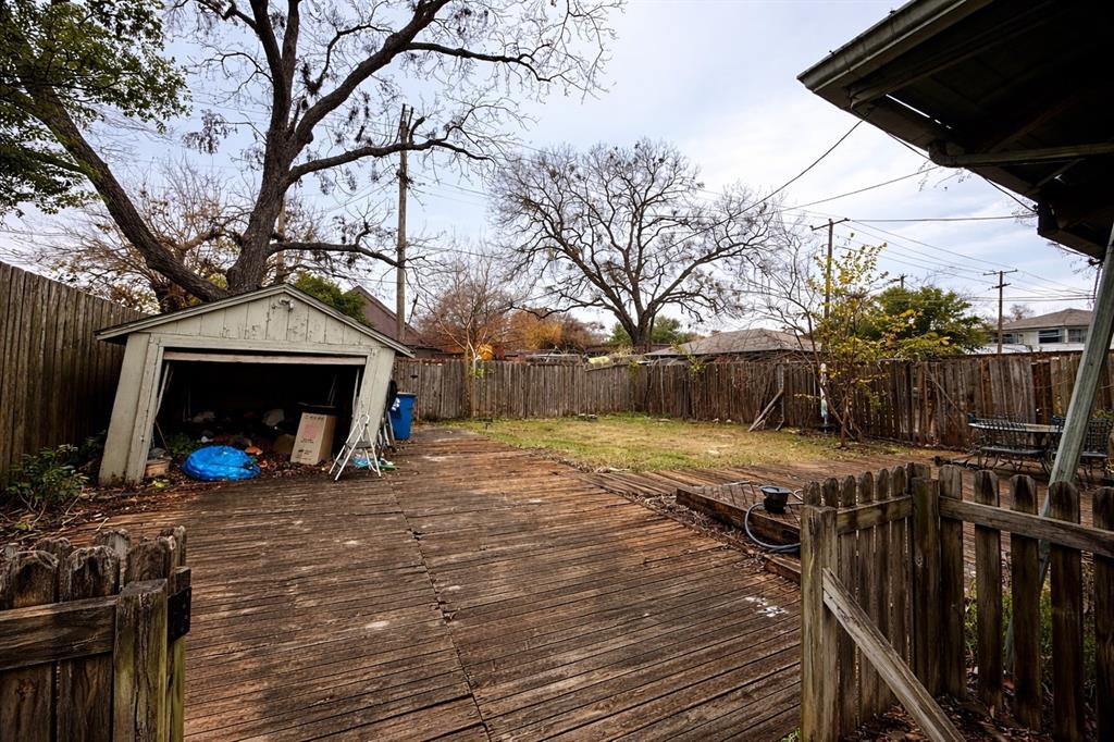 115 North Montclair Avenue Dallas, TX 75208 - Photo 12 of 13 Wooden deck featuring a fenced backyard, a storage shed, and a detached garage