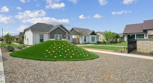 a view of a room with gym equipment and large windows